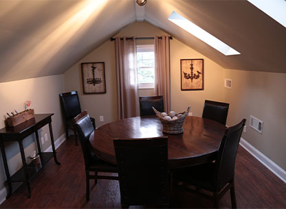 5 chairs surrounding a round table.